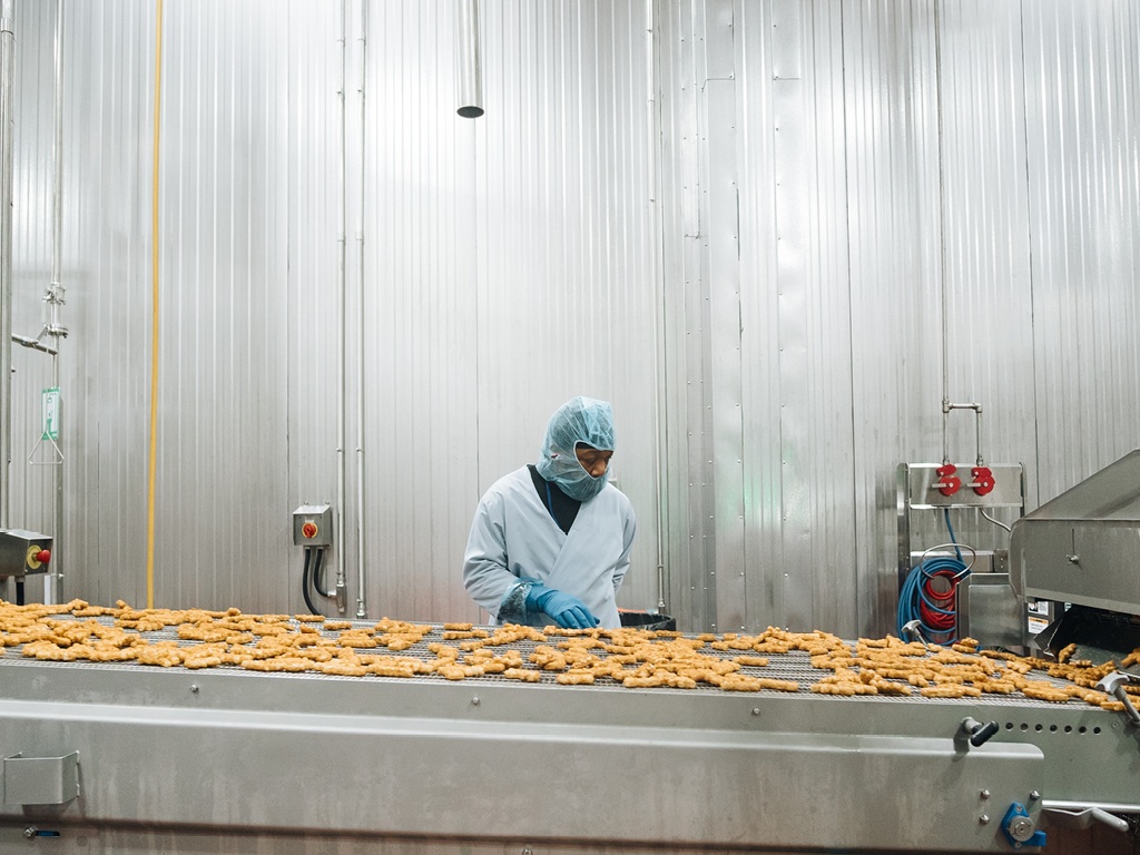 Workers and equipment on a Tyson Foods production line