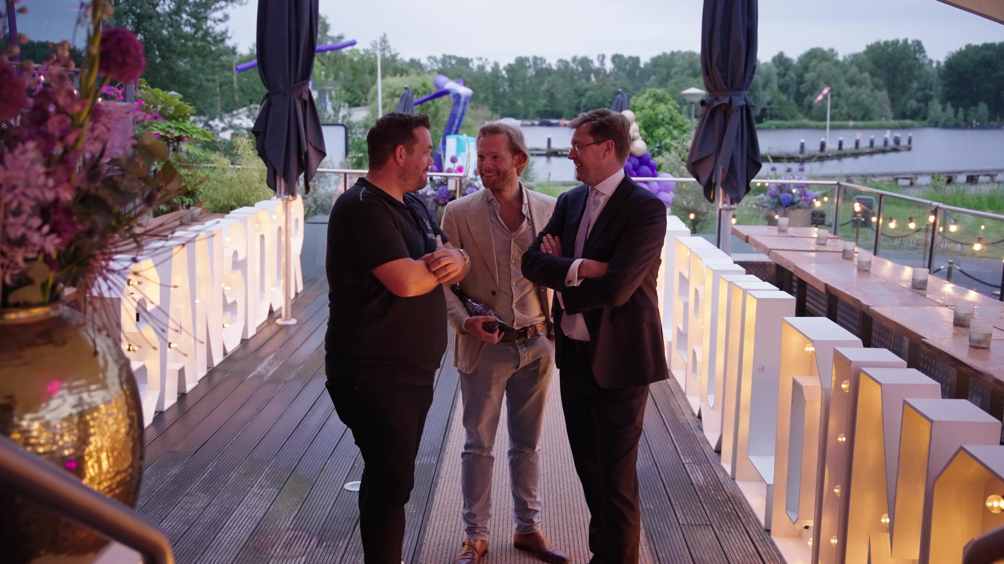 Udo Waltman, at right, talking with two people at an outdoor HumbleBuildings event