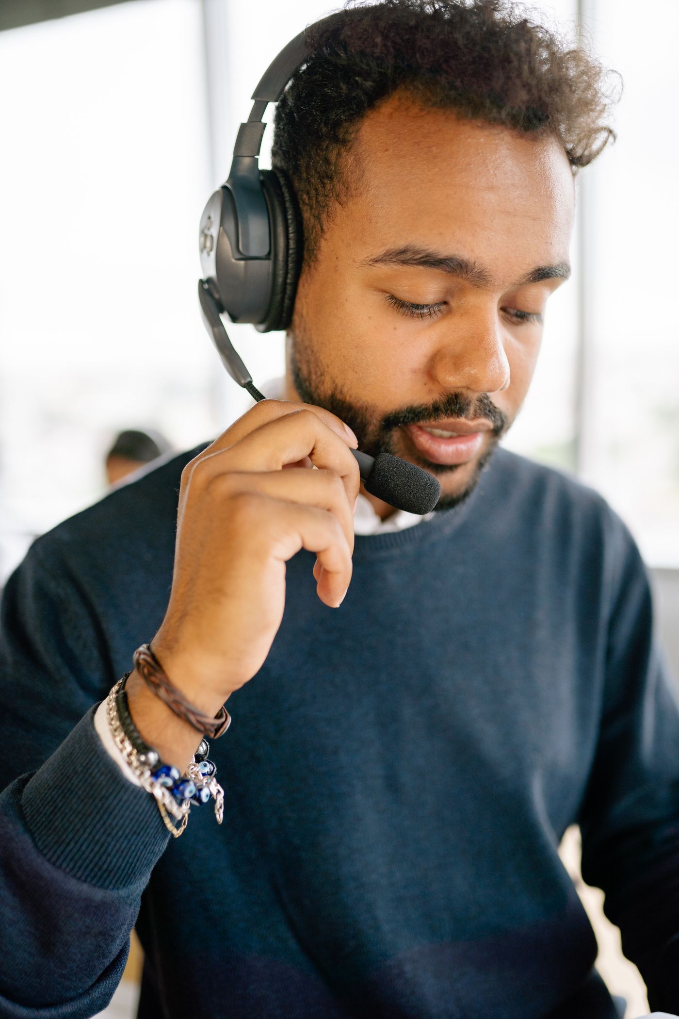 A human customer-support agent concentrates during a headset call