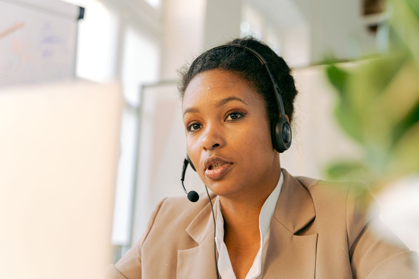 A contact-center professional listens carefully while working at a computer