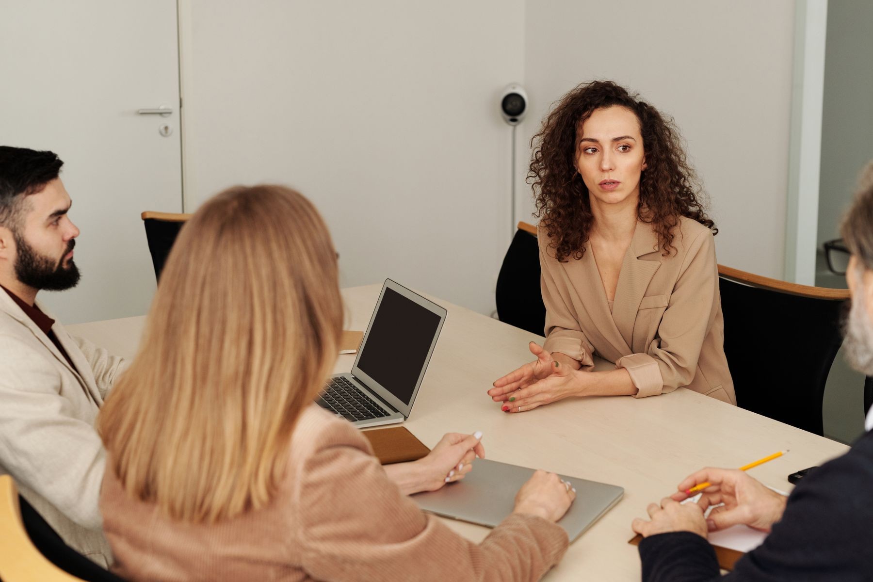 Colleagues reviewing documents around an office meeting table.