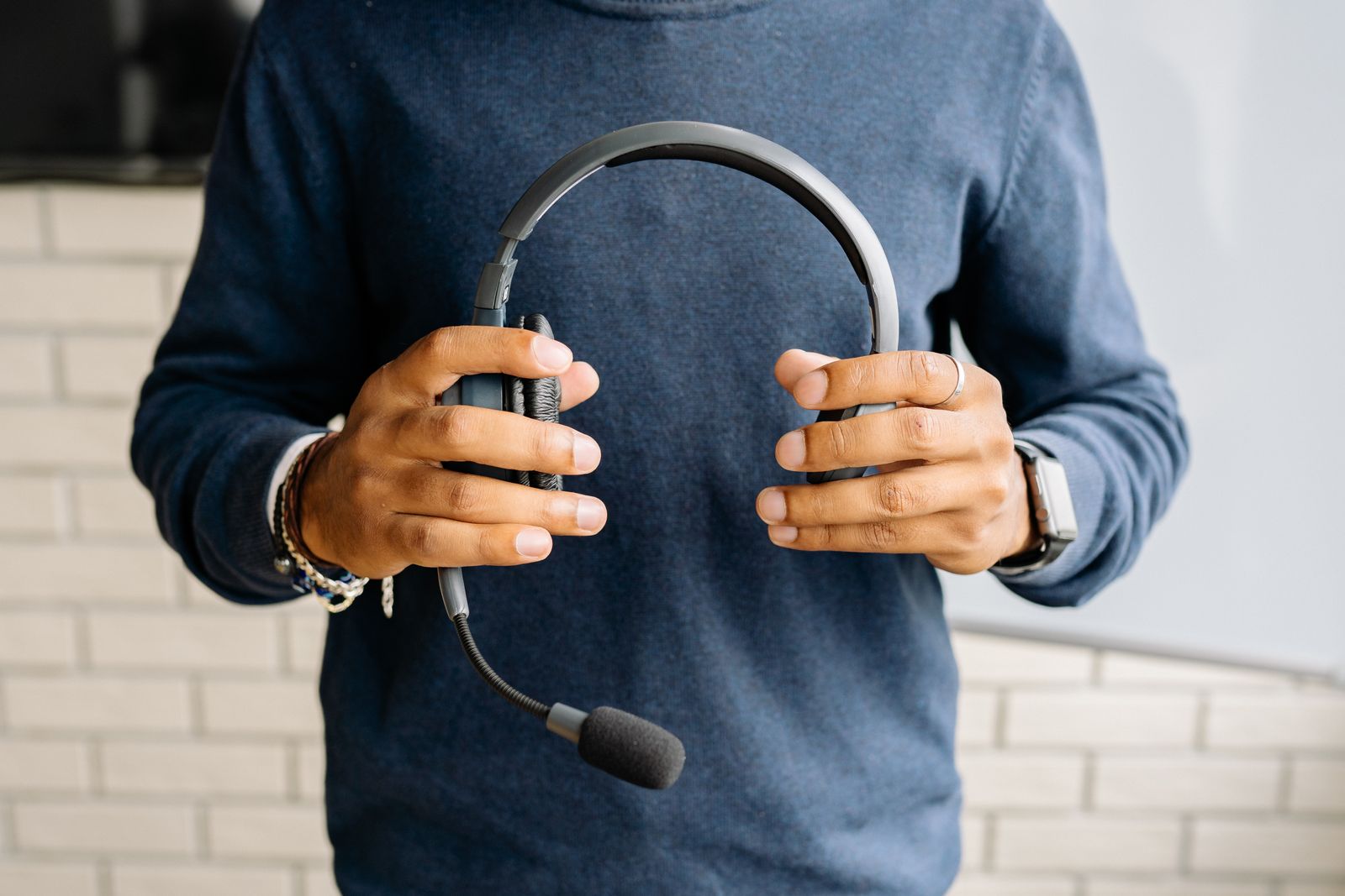 Close-up of a person holding an office headset