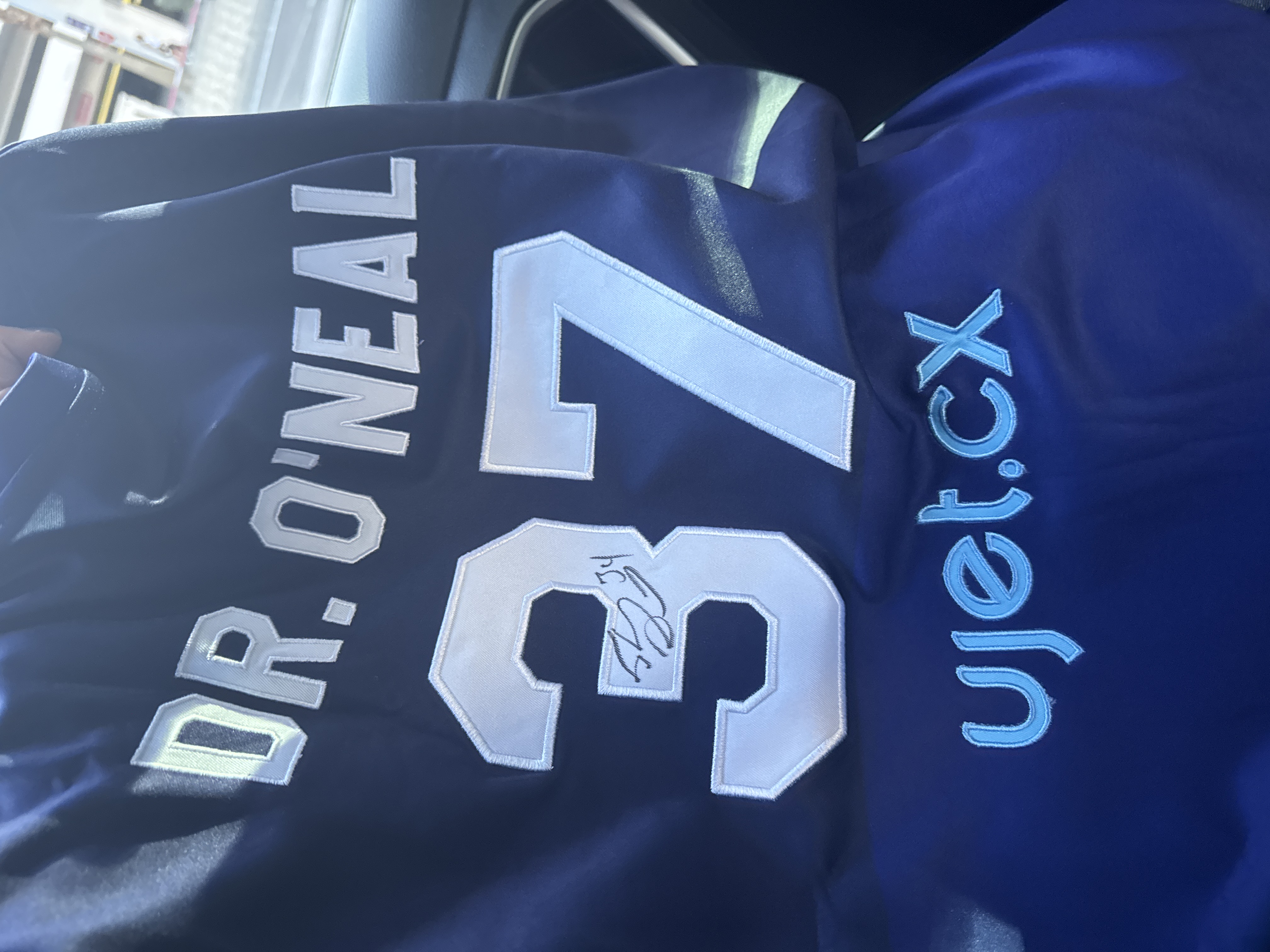 Close-up of a navy jersey reading DR. O'NEAL, number 37, with ujet.cx down the sleeve, signed by Shaquille O'Neal
