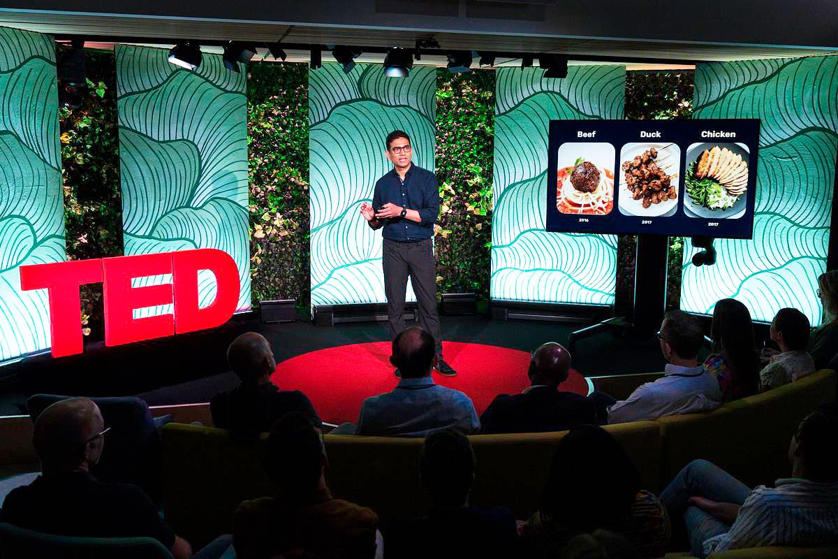 Uma Valeti presenting a timeline of cultivated beef, duck and chicken at a TED event