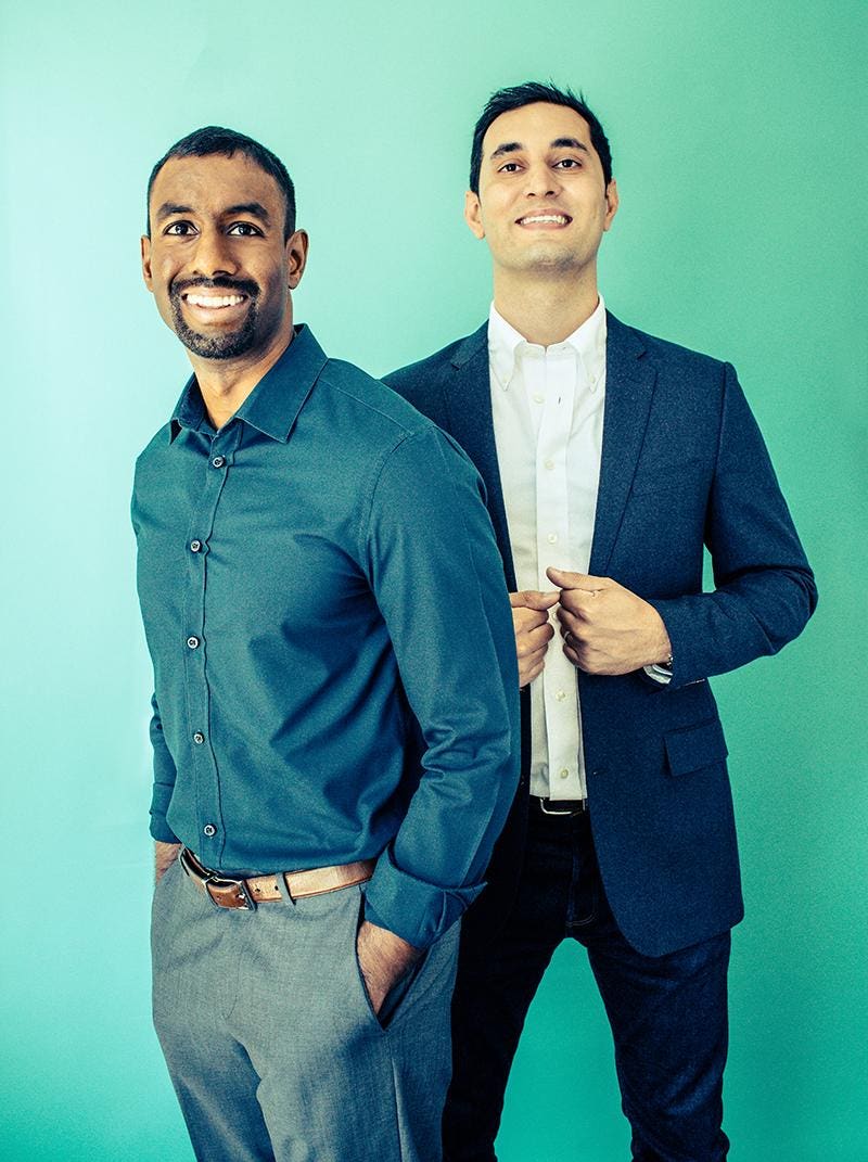 Truepill co-founders Sid Viswanathan at left and Umar Afridi at right, standing against a teal wall
