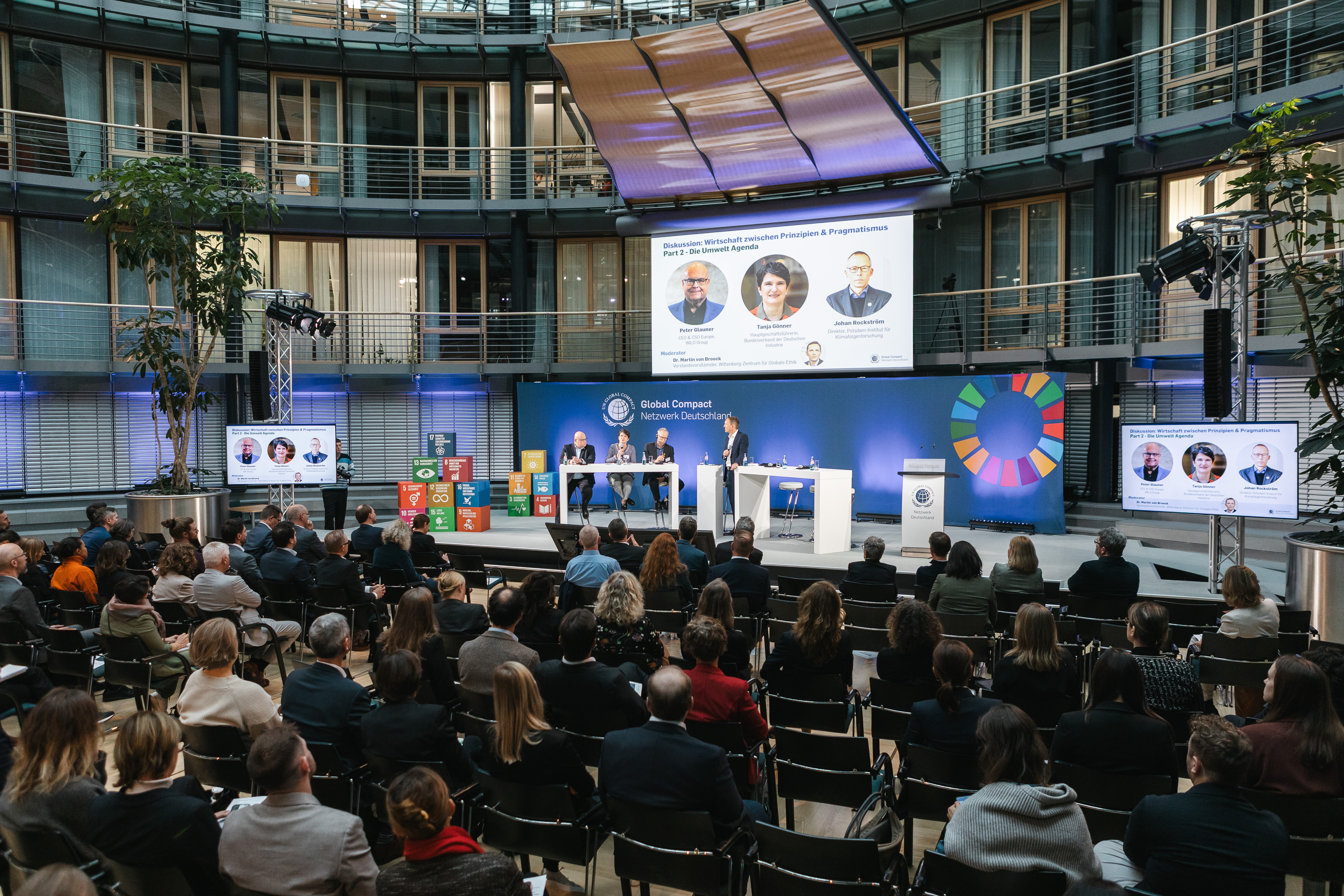 Audience watching an environmental panel at the German network’s 2025 anniversary conference
