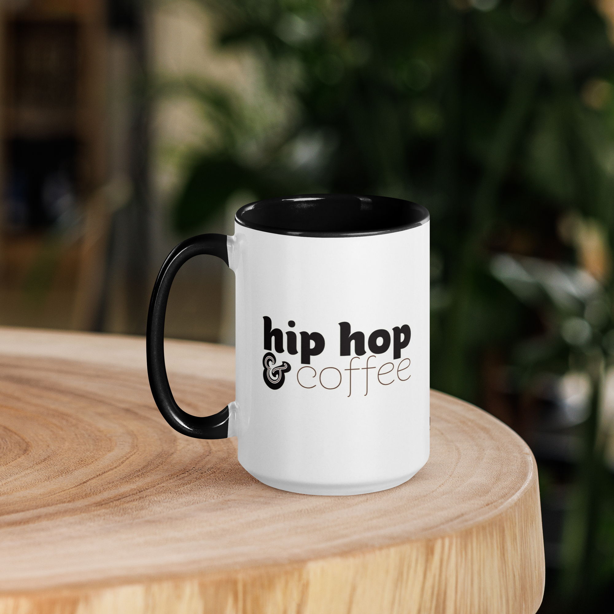 Hip Hop and Coffee mug with a black handle, presented on a wooden table in a company product mockup