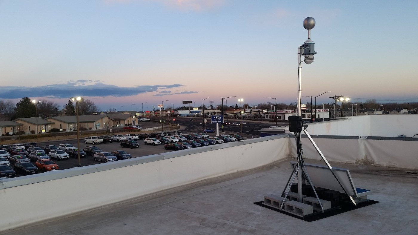 Understory Dot weather sensor installed on the roof of an automotive dealership