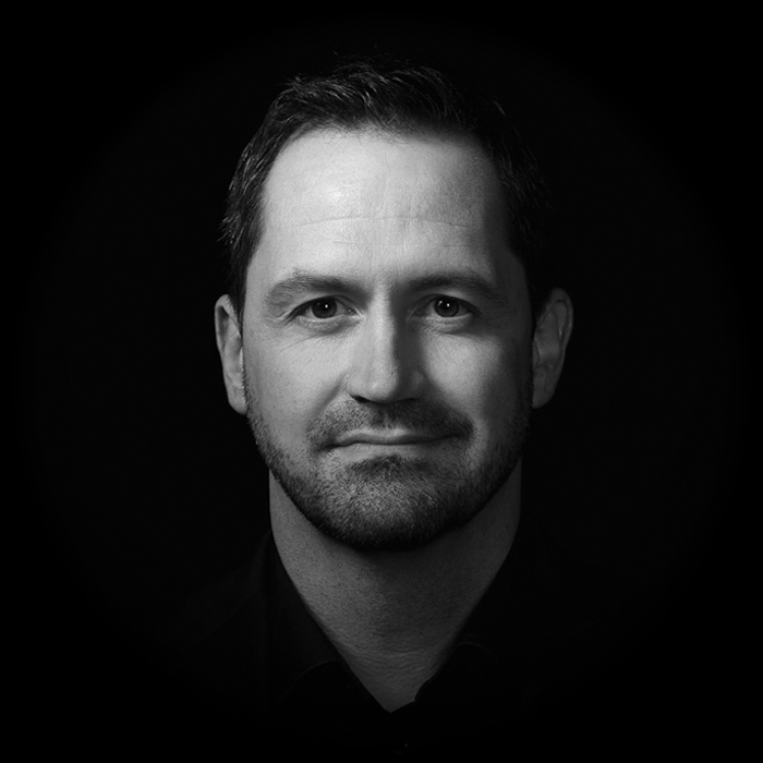 Black-and-white portrait of Unearth co-founder and CEO Bryan Merica