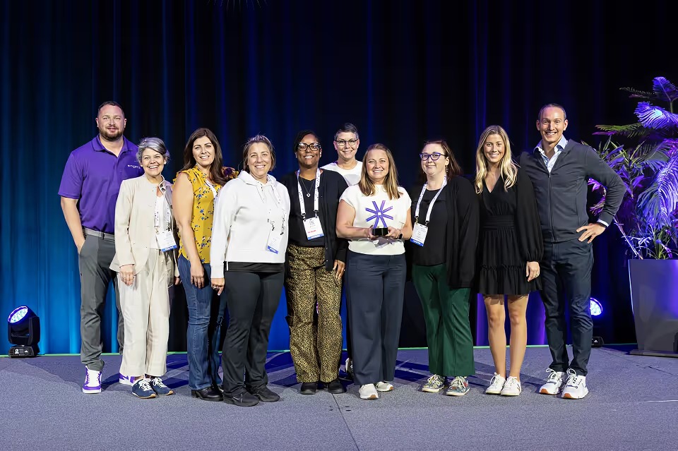 Group pictured on Momentus Technologies’ company about page, standing on a stage