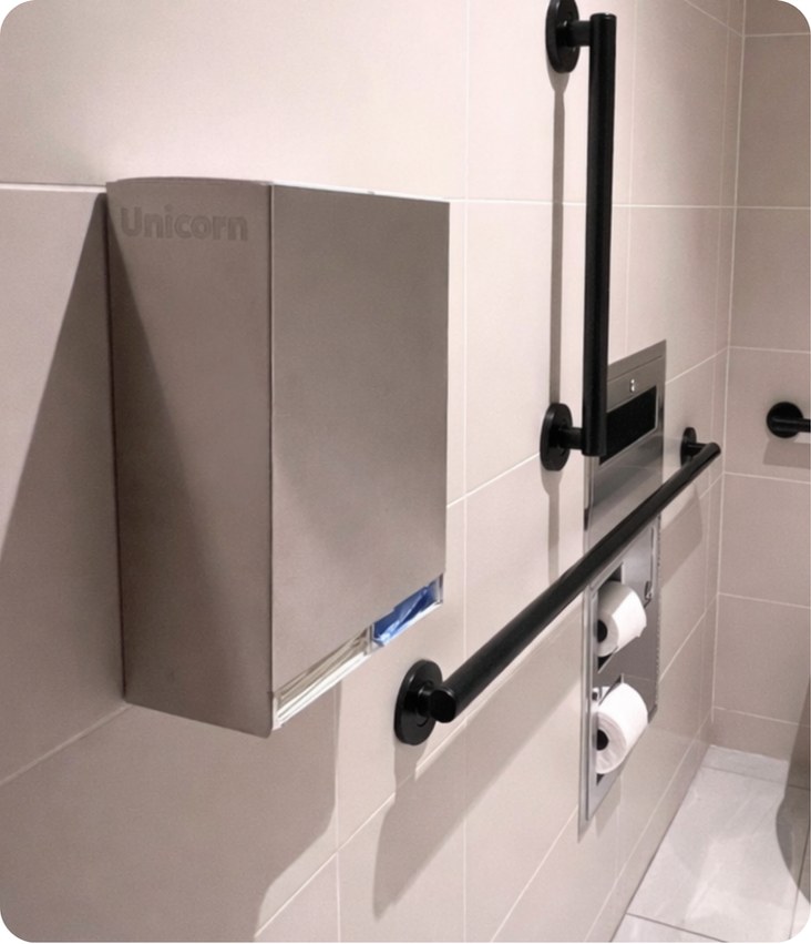 UNICORN stainless-steel dispenser mounted inside a bathroom stall