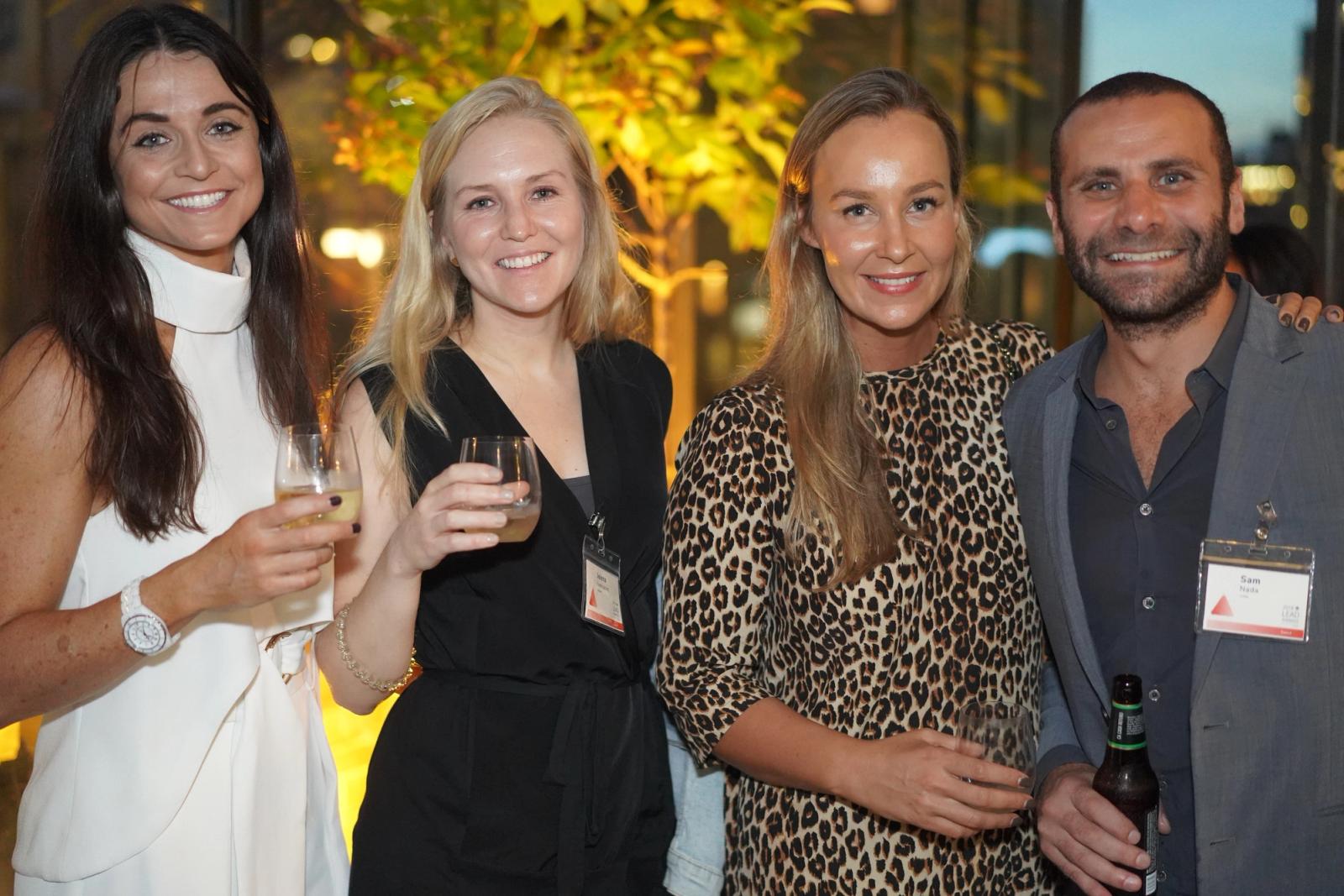 Four people pictured at an event in Unified’s careers and culture photography
