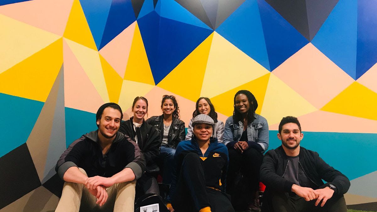 Unified employees gathered in an office, from the company’s culture page