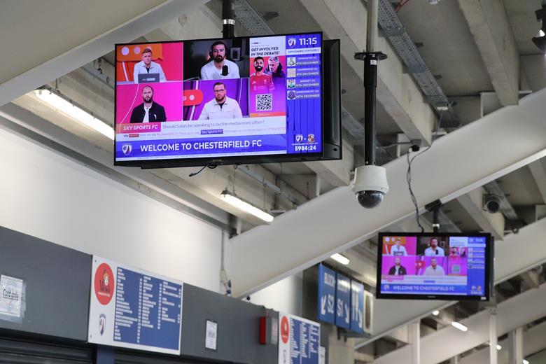 Ceiling-mounted Chesterfield FC concourse screens show live sports alongside club information