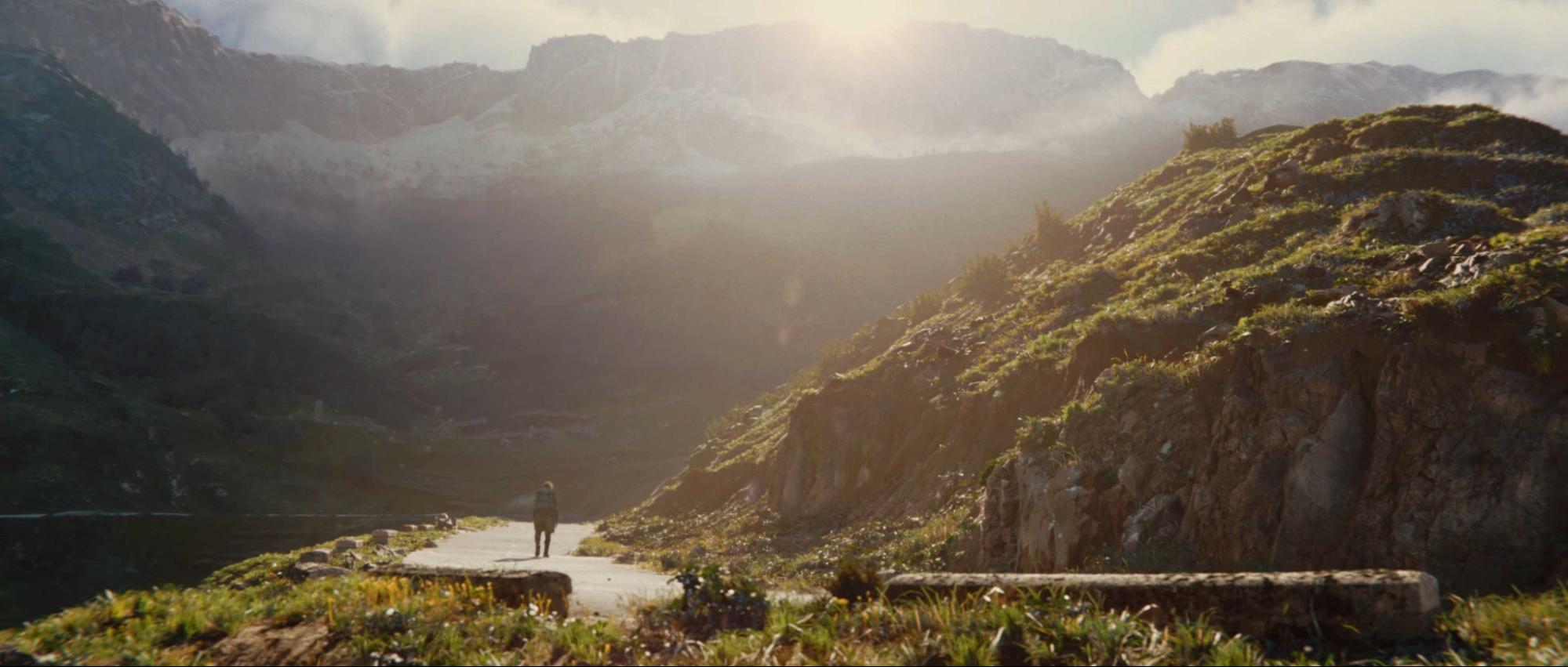 A lone character stands in a sunlit rocky valley in Unity’s Time Ghost cinematic