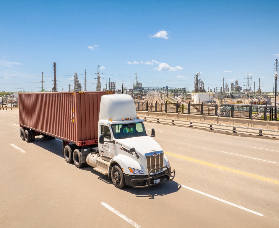 A truck traveling on a road in an official Universal Logistics photograph