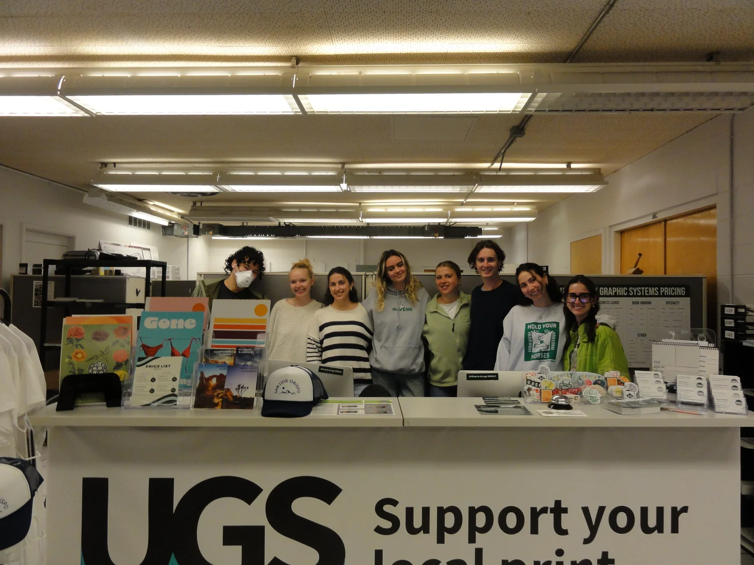 University Graphic Systems student managers standing behind the service counter in the print shop