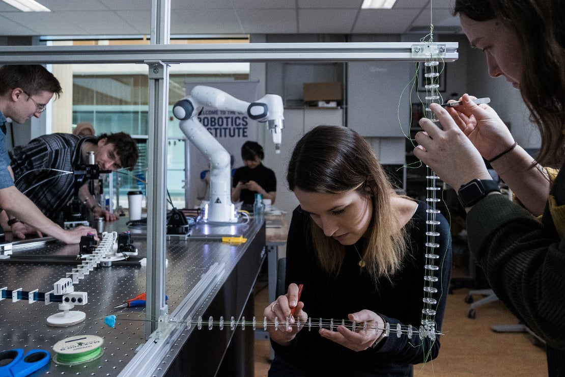 Researchers working with a robot at the University of Toronto Mississauga