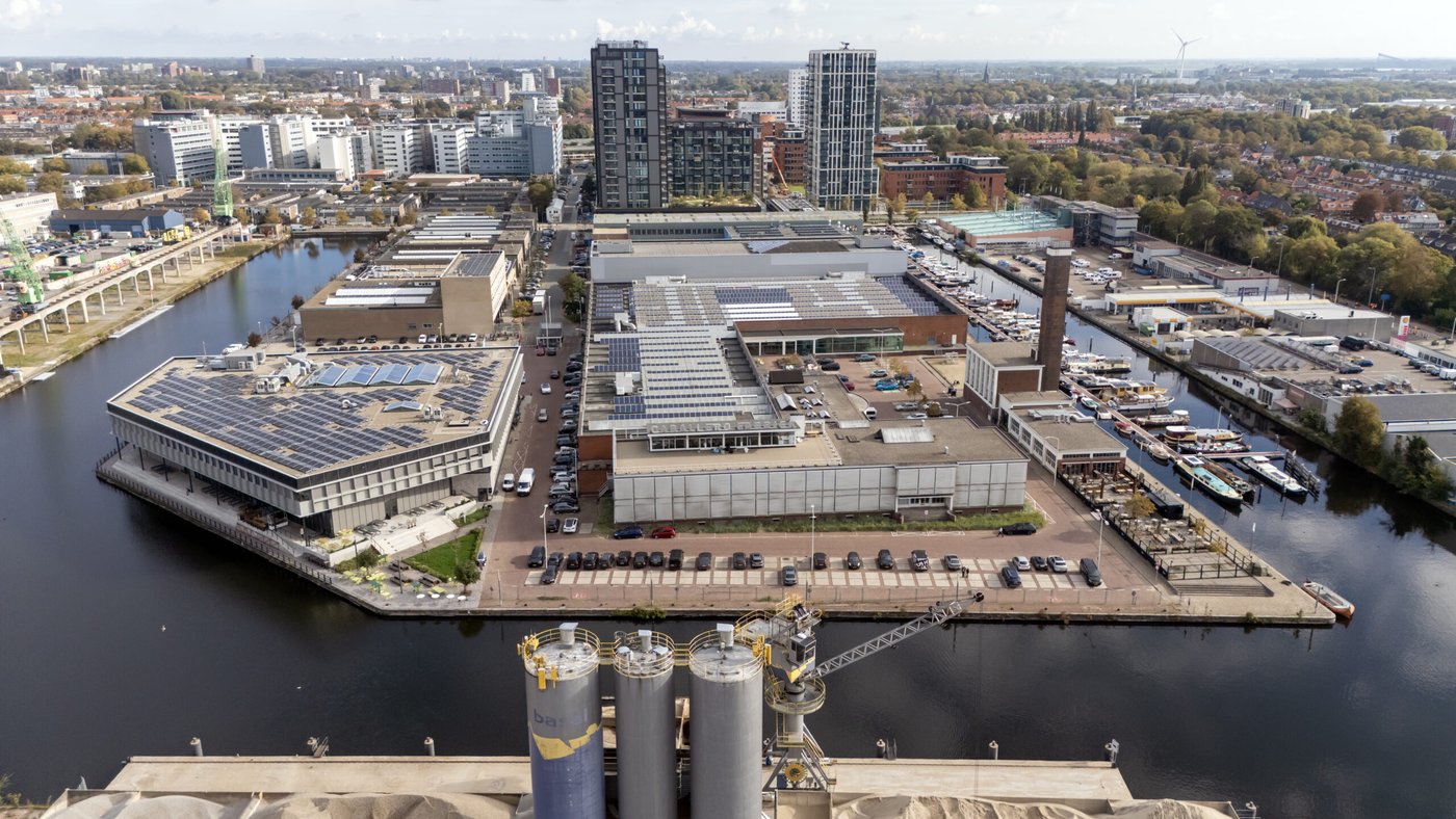 Aerial view of the Titaan and Caballero buildings with solar panels beside the canal