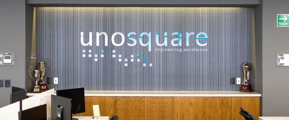 Unosquare office reception with its name on the wall and trophies on either side