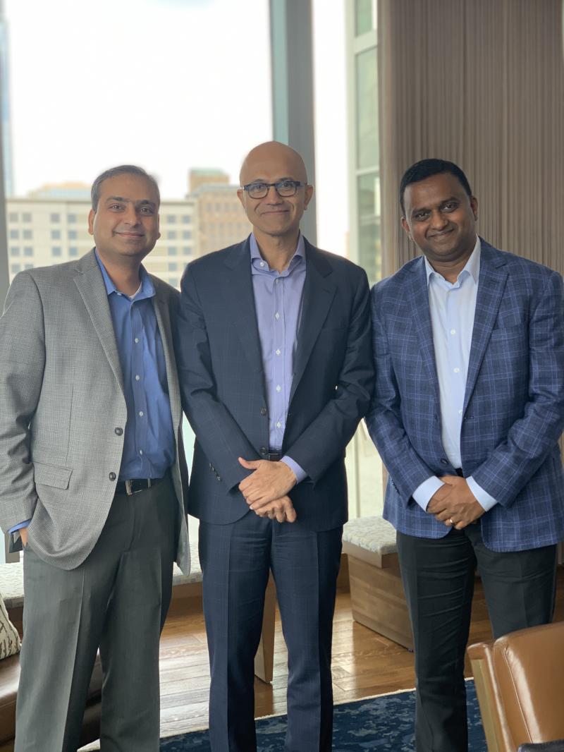 Upen Varanasi at right with Satya Nadella in the centre and another meeting participant at left