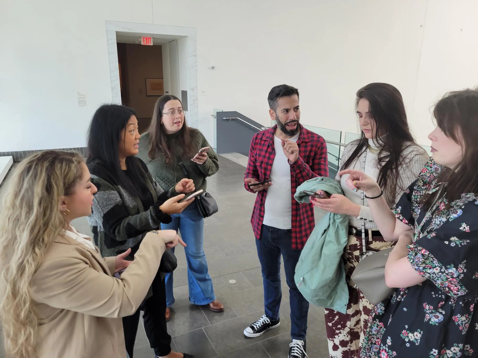 UpSpring team members talking together during a museum visit
