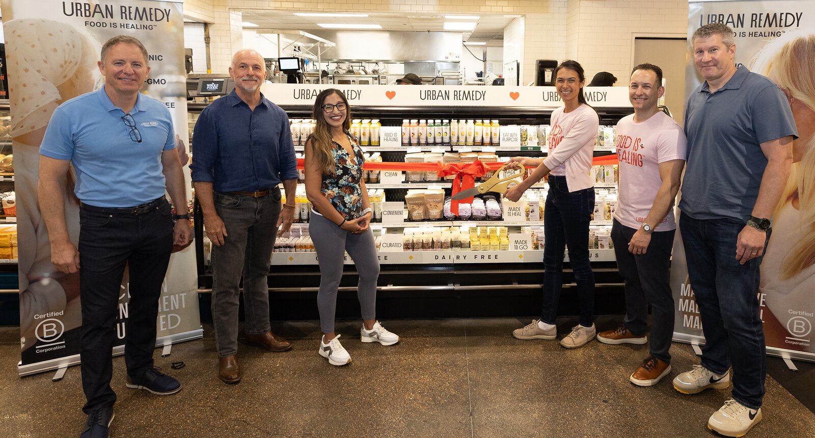 Urban Remedy and Whole Foods Market representatives celebrating their expanded distribution partnership