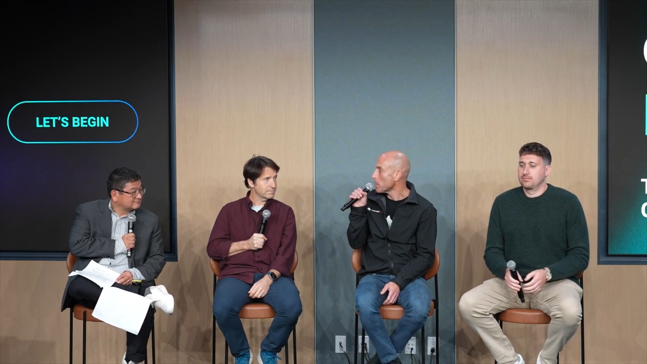 Uri Marchand, second from right, speaking into a microphone on a four-person GamesBeat Next panel