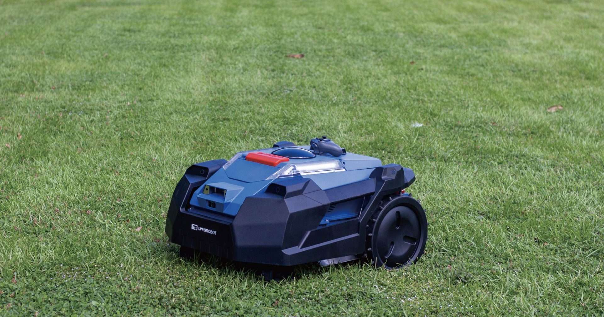 A URSROBOT NEXMOW robotic mower on grass