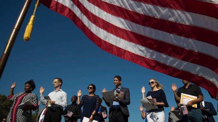 People beneath an American flag in the artwork for Eve Levi’s U.S. work-visa course