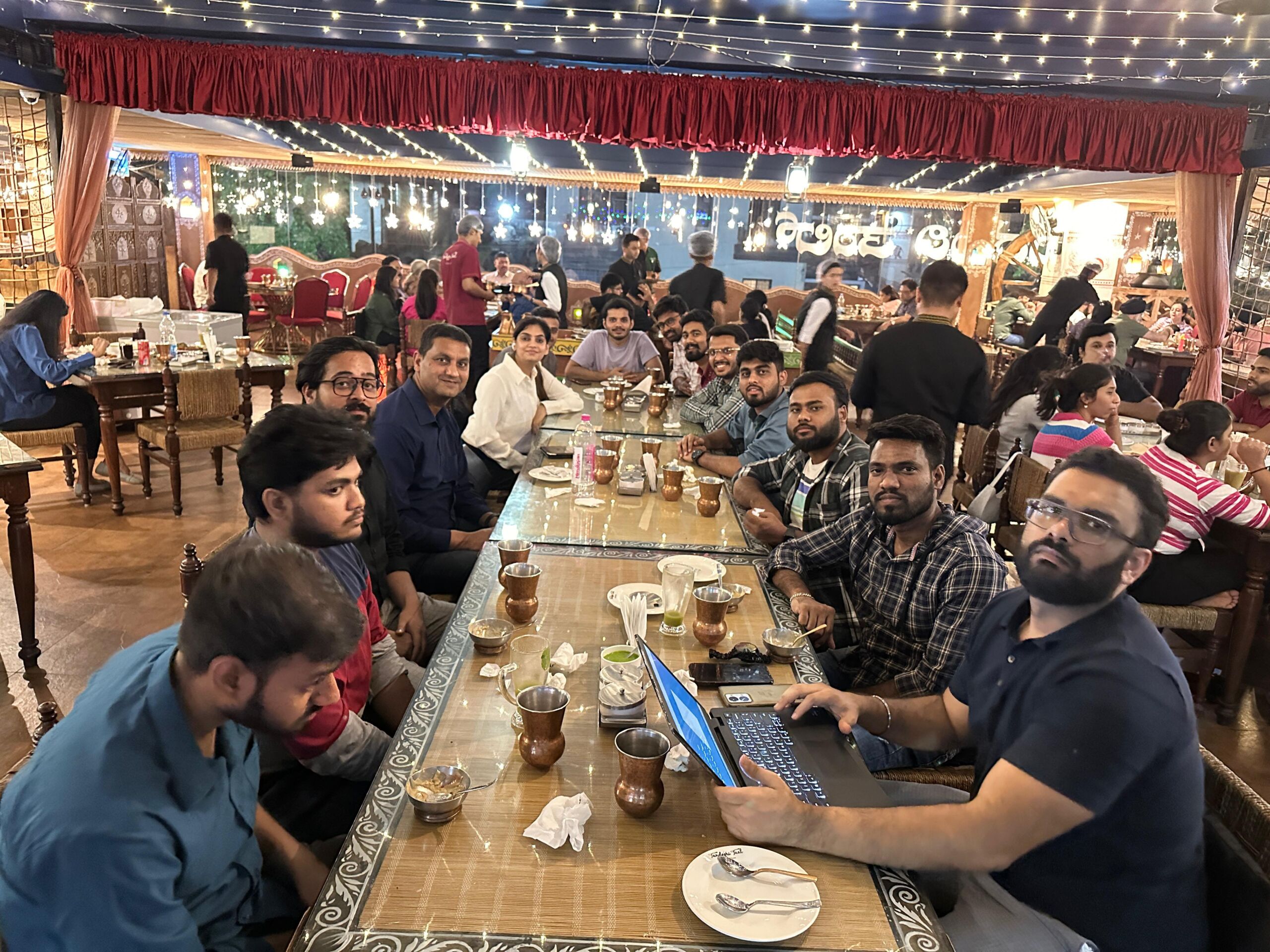 UsefulBI team members gathered around a long restaurant table