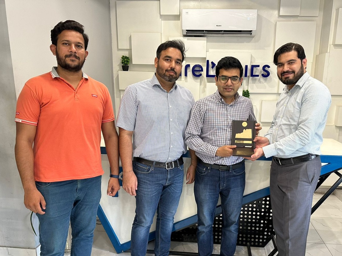 Usman Akbar, second from right, holding a plaque with University of Central Punjab visitors at PureLogics