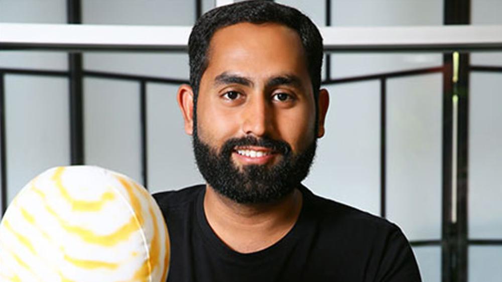 Usman Iftikhar holding a model globe while discussing space and Earth