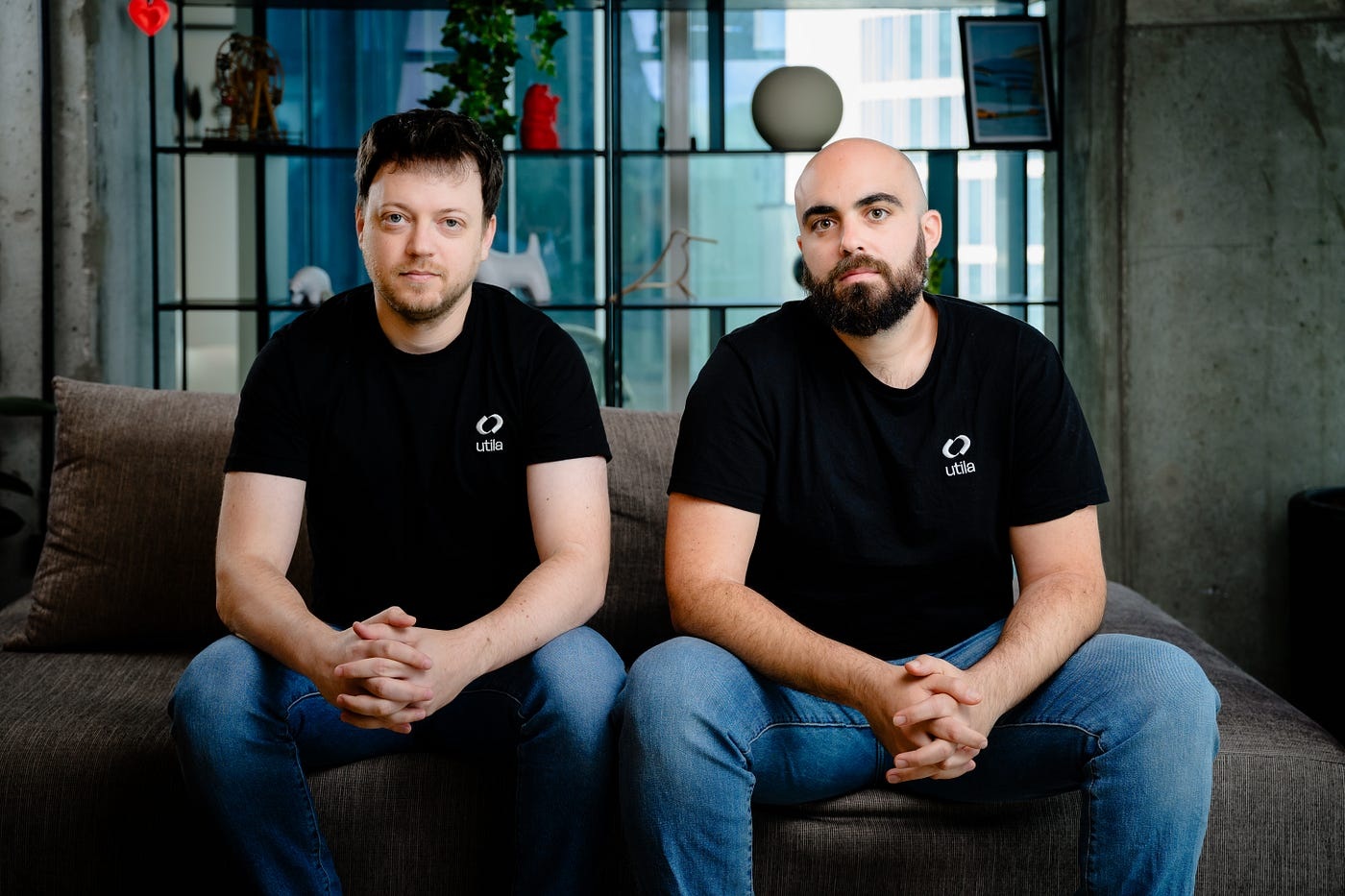 Utila co-founders Sam Eiderman on the left and Bentzi Rabi on the right, seated in matching black company shirts.