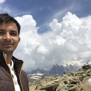 Utkarsh Garg outdoors in front of a mountain landscape