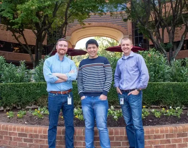 Prometheus executives Ed Mason, Eric Huang and Jay Golonka standing outside in the photograph accompanying the Utopia acquisition announcement
