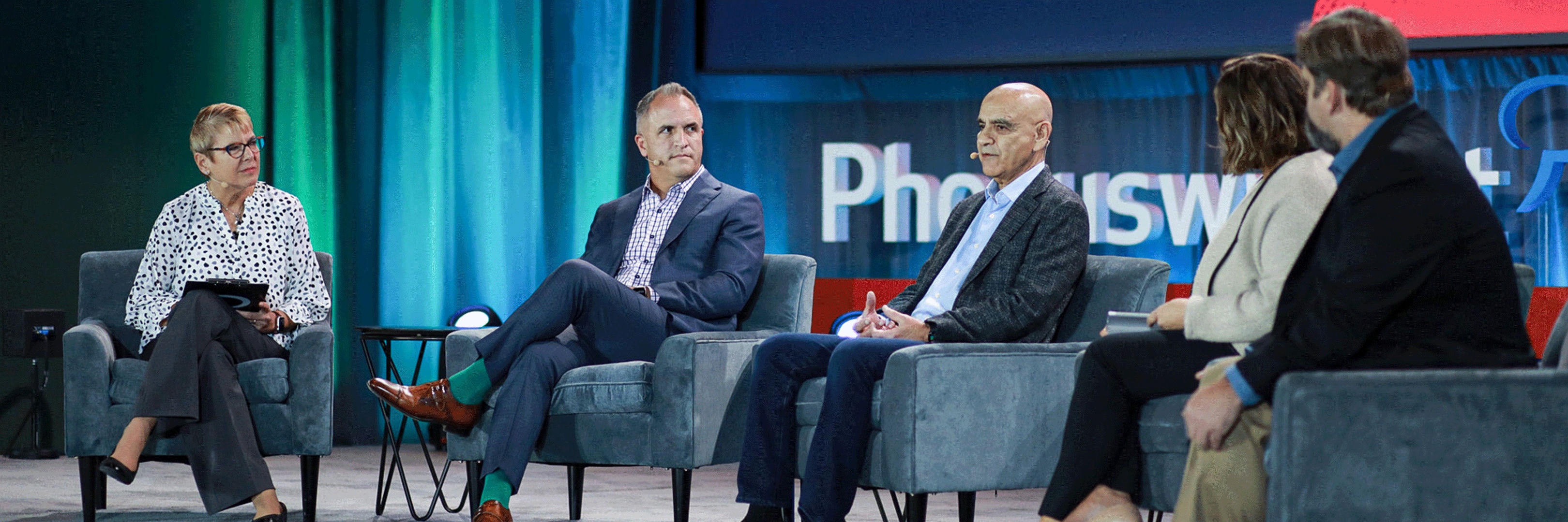 Vajid Jafri seated at the center of a five-person panel at the 2021 Phocuswright Conference