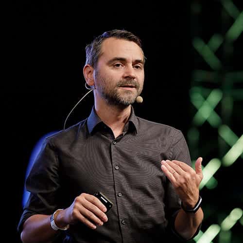 Valentin Radu wearing a headset microphone while speaking at an event