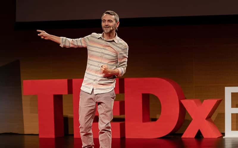 Valentin Radu speaking on a stage