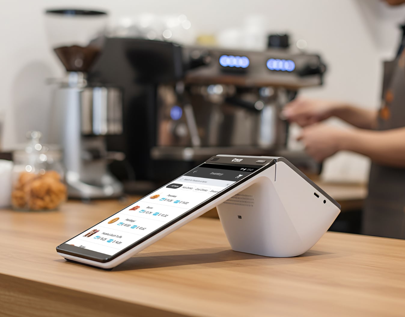 Valor VP800 payment terminal on a café counter, with an espresso machine behind it