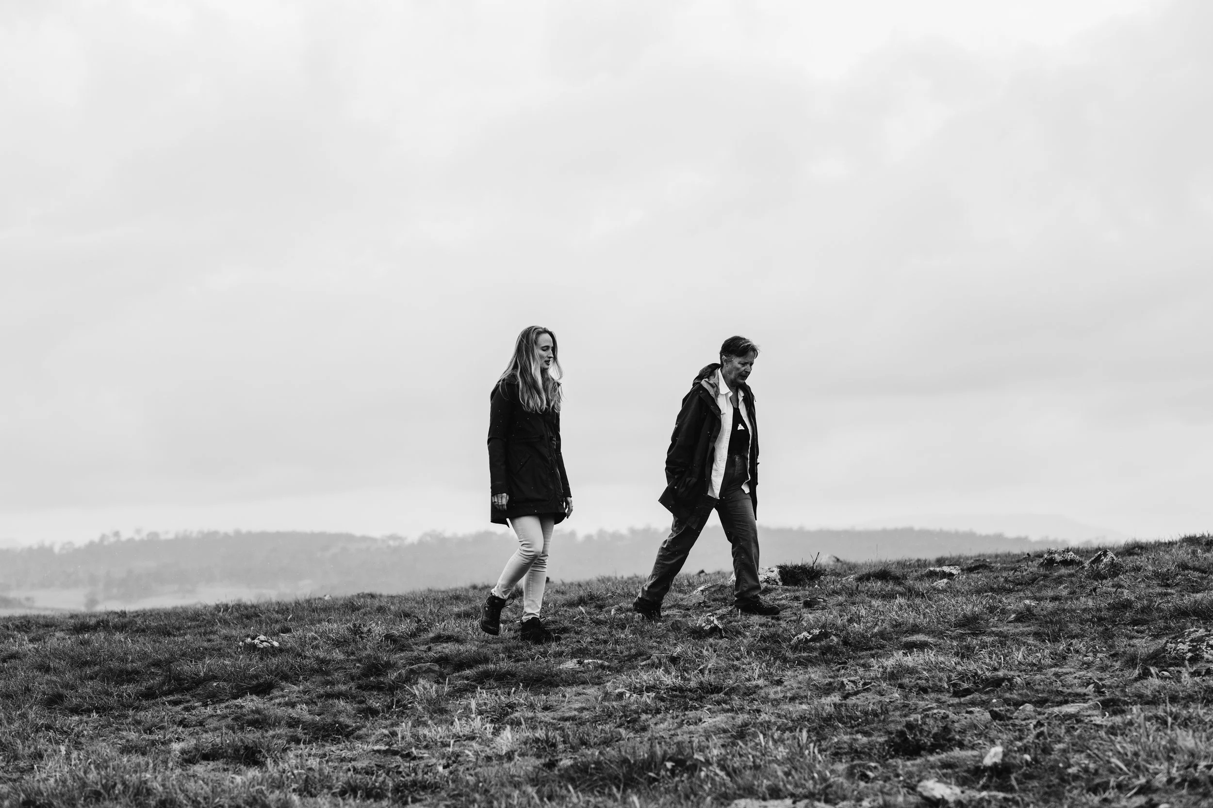 Vanessa Barboni Hallik walking across a grassy farm with White Gum founder Nan Bray