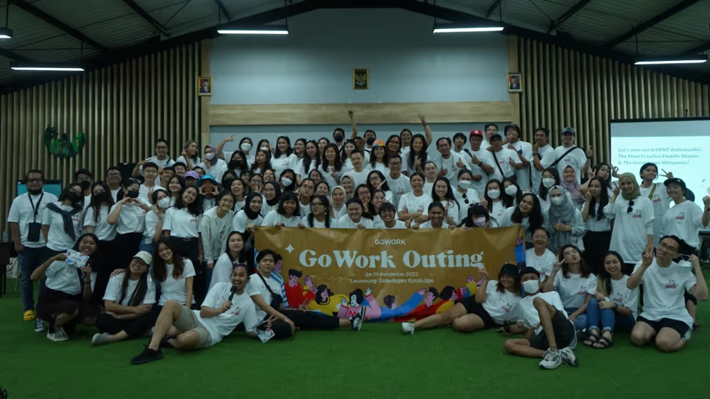 GoWork team gathering behind a banner at the November 2022 company outing