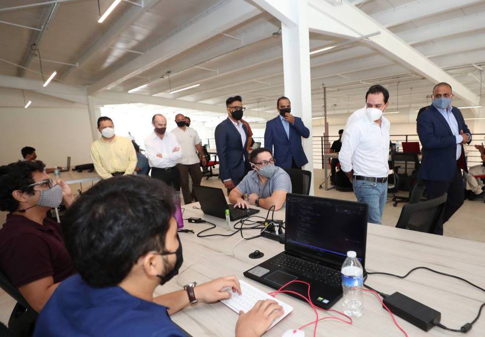 Ksquare employees at their computers during the May 2021 office visit in Mérida