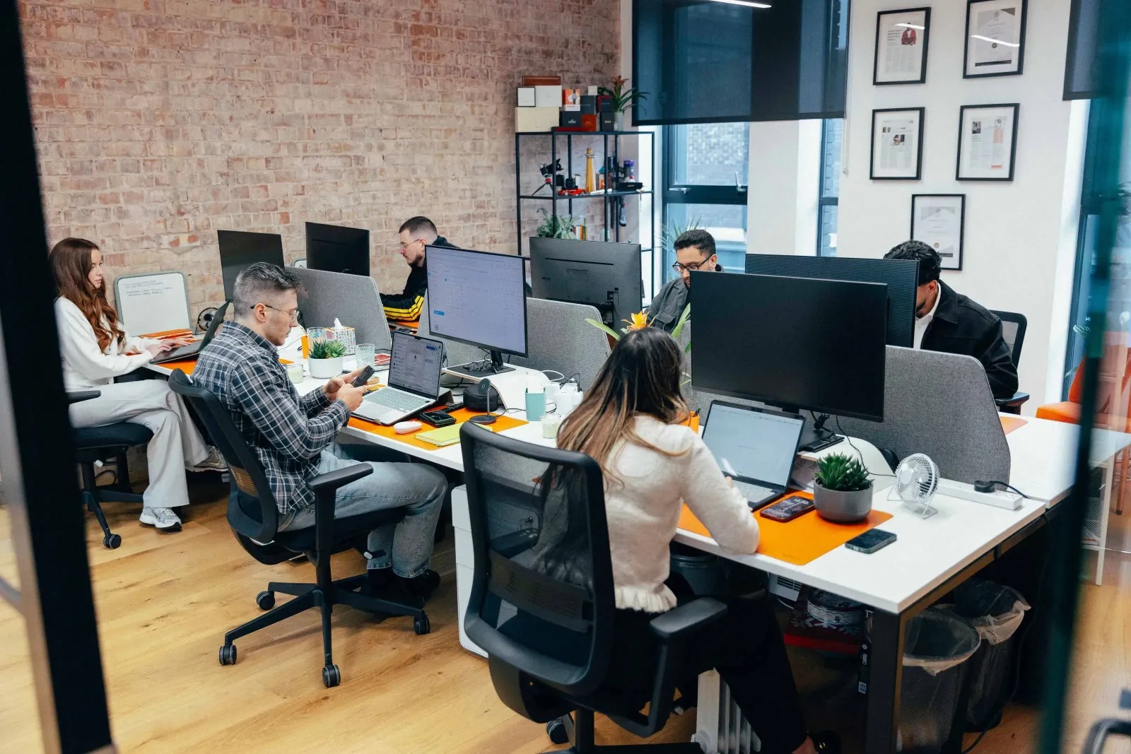 VARTEQ team members working at desks in a shared office