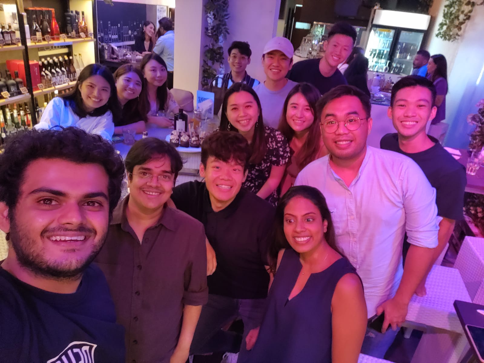 WhyQ colleagues gathered for a group photograph, with Varun Saraf seated second from the left in the foreground