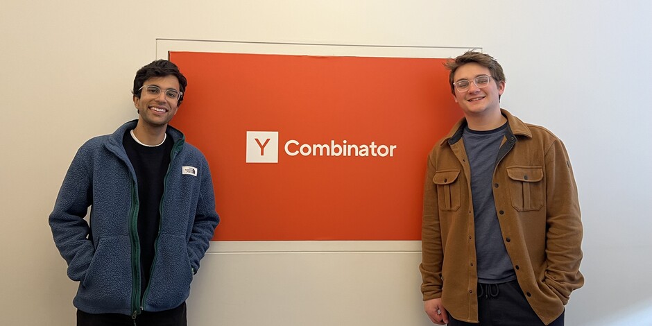 Varun Tandon, left, and Ryan Johnston beside the Y Combinator sign