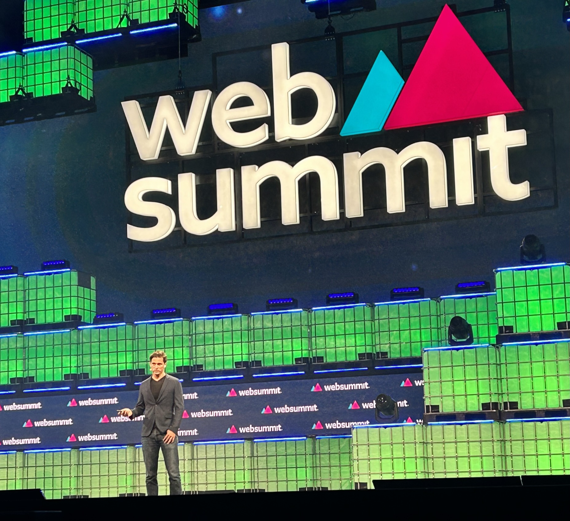 Vasco Pedro speaking beneath the large Web Summit sign in 2023