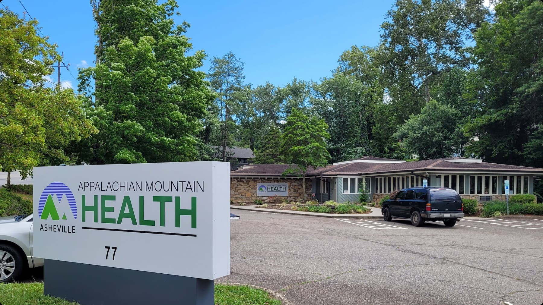 Exterior of an Appalachian Mountain Health clinic with its roadside sign