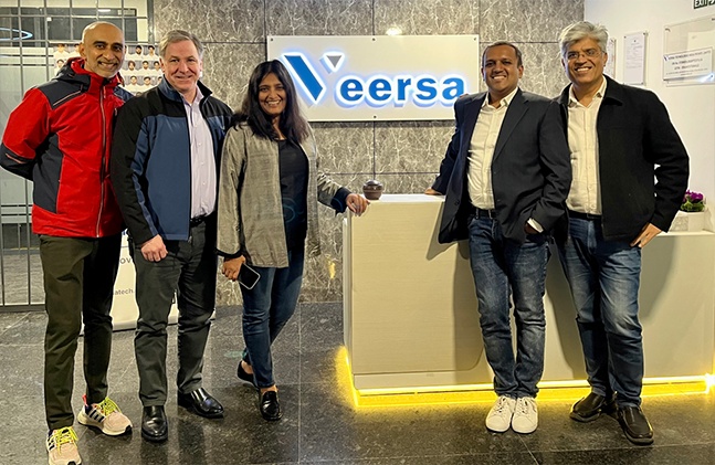 Five people gathered beside the reception desk in Veersa’s office