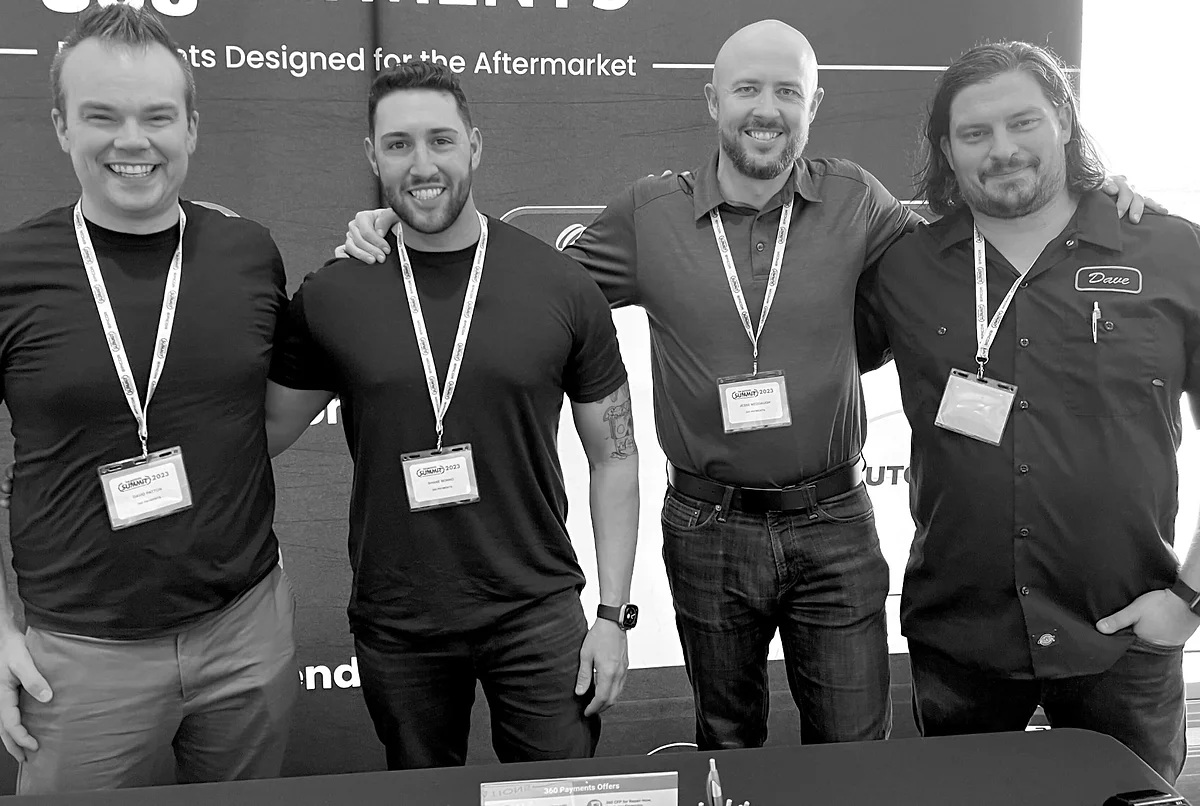 Four team members pictured together at an automotive industry event on Vehlo’s About page